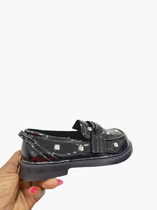 Glossy black leather shoes with silver stones