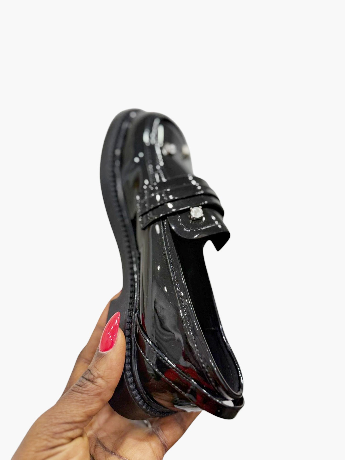 Glossy black leather shoes with silver stones