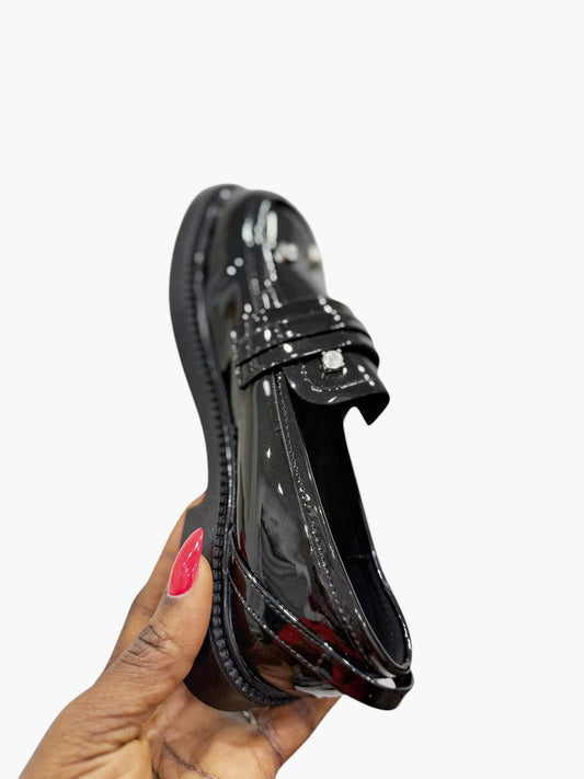 Glossy black leather shoes with silver stones